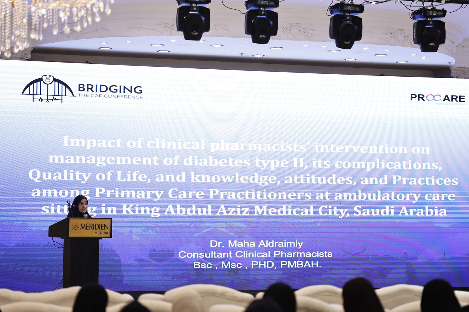 A speaker at the lectern presenting a study on clinical pharmacists' interventions in diabetes care